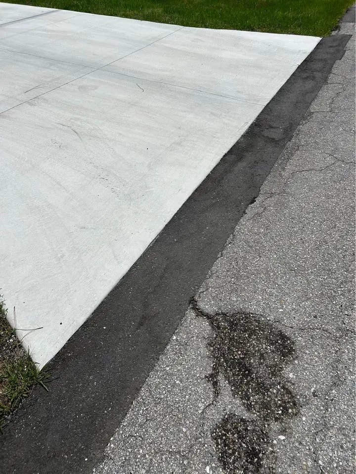 large crack in asphalt which was cut out and replaced with fresh asphalt mix